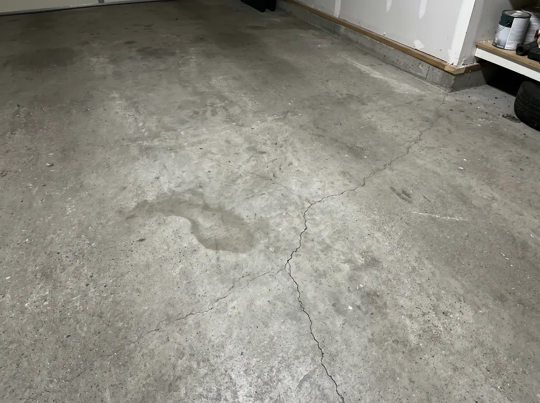 A quick homeowner phone photo of a plain concrete garage floor, the kind customers text us for a fast quote