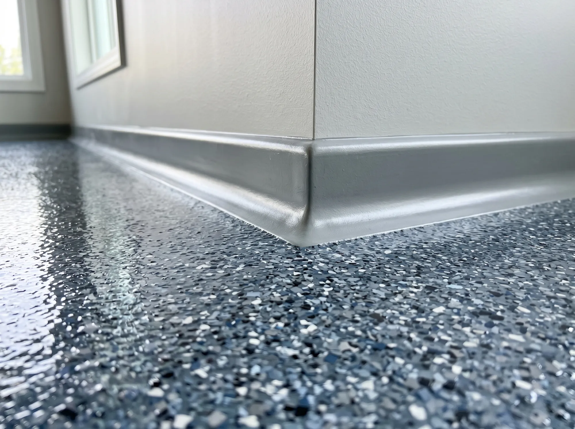 Close-up of a finished epoxy floor with a clean coved edge