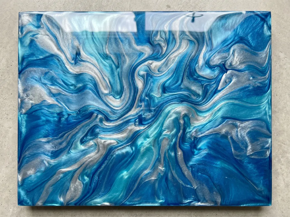 Swirled navy metallic epoxy floor with a mirror-like gloss